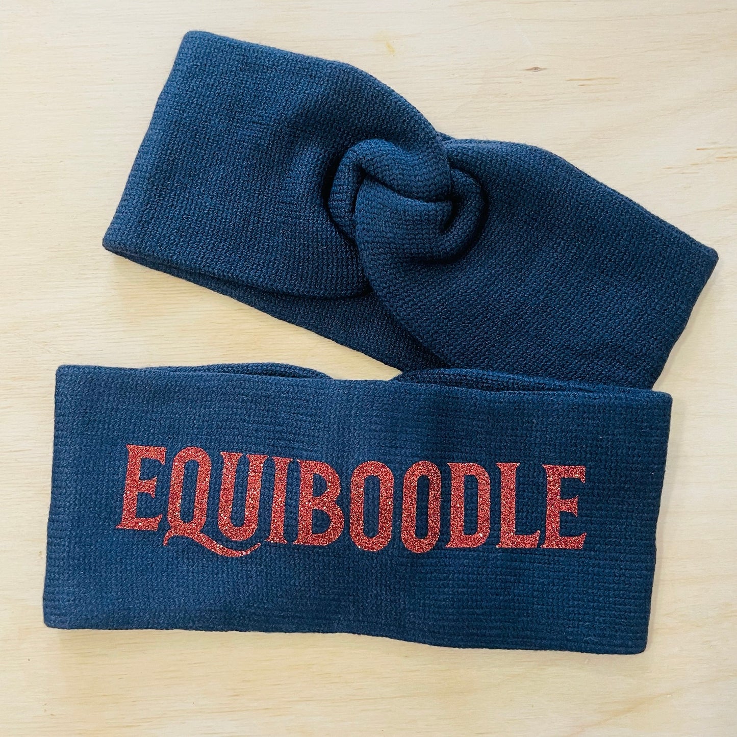 Equiboodle navy knitted headband with bronze sparkle logo