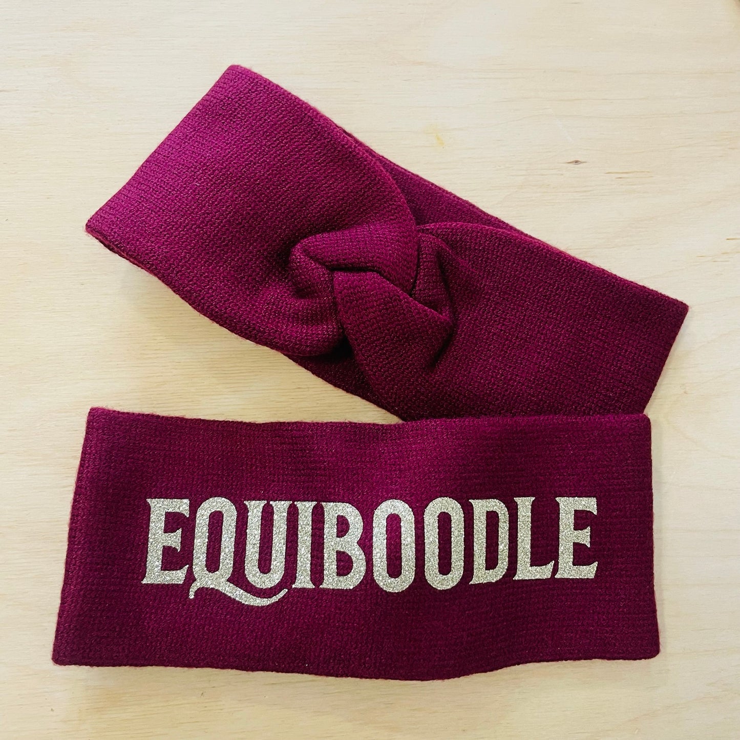 Equiboodle burgundy knitted headband with champagne gold logo