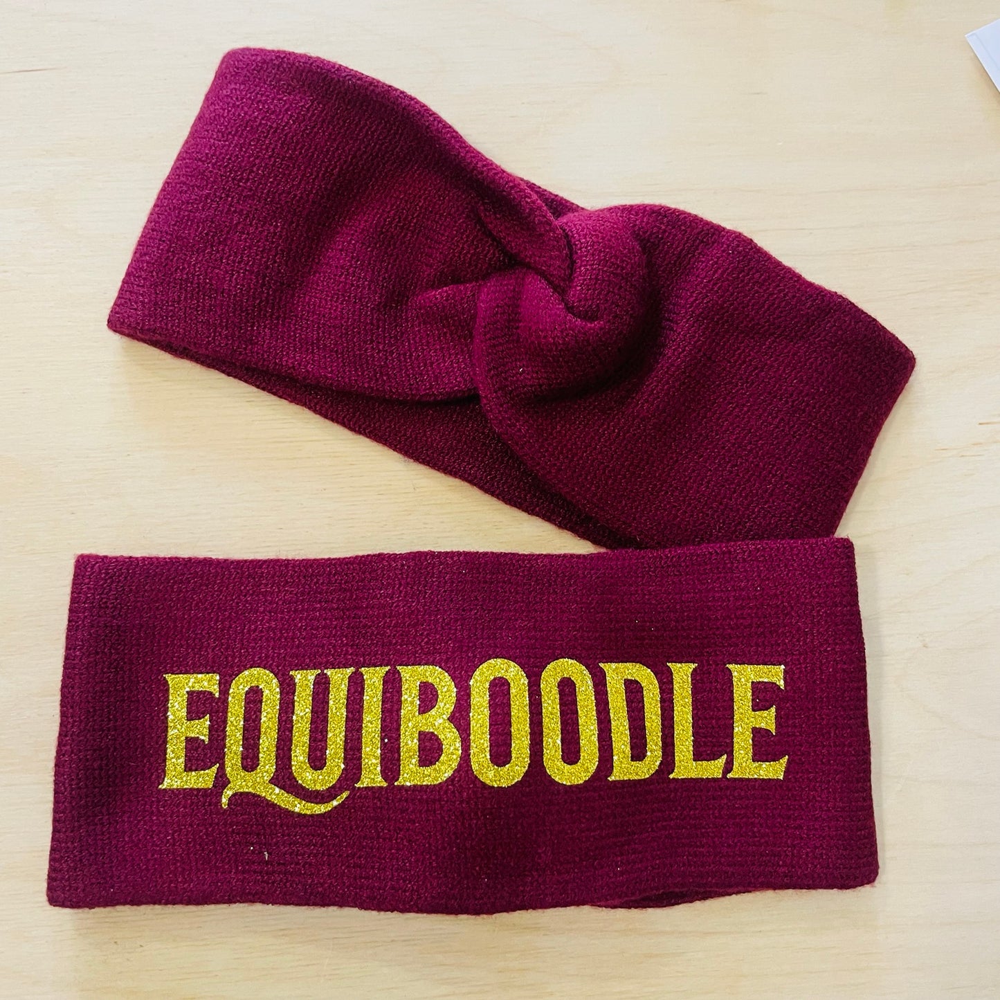 Equiboodle burgundy knitted headband with gold sparkle logo