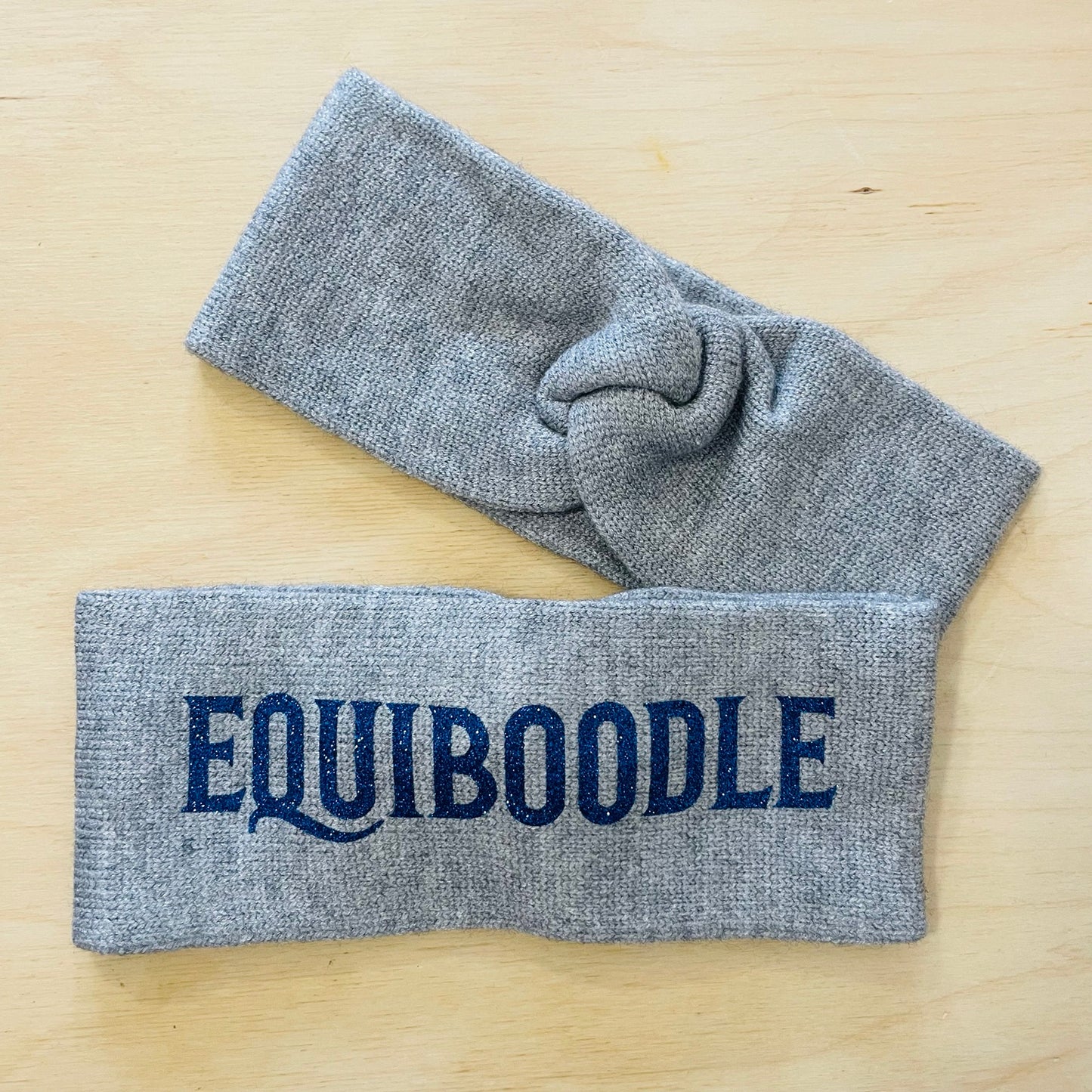 Equiboodle grey knitted headband with blue sparkle logo