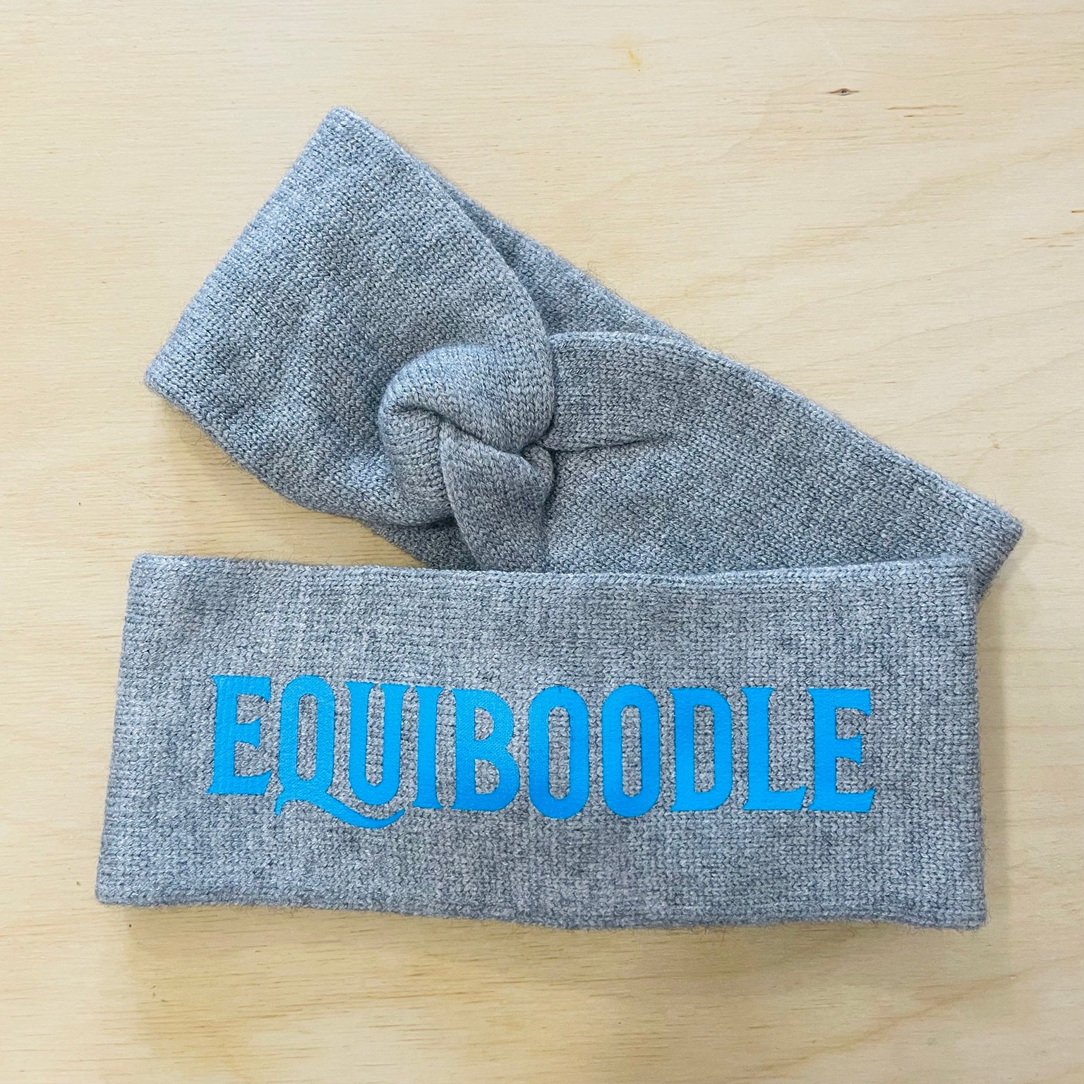 Equiboodle grey knitted headband with electric blue logo