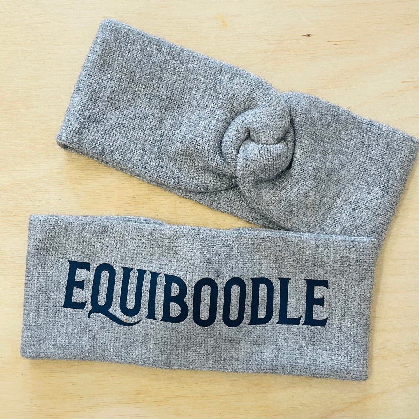 Equiboodle grey knitted headband with navy blue logo