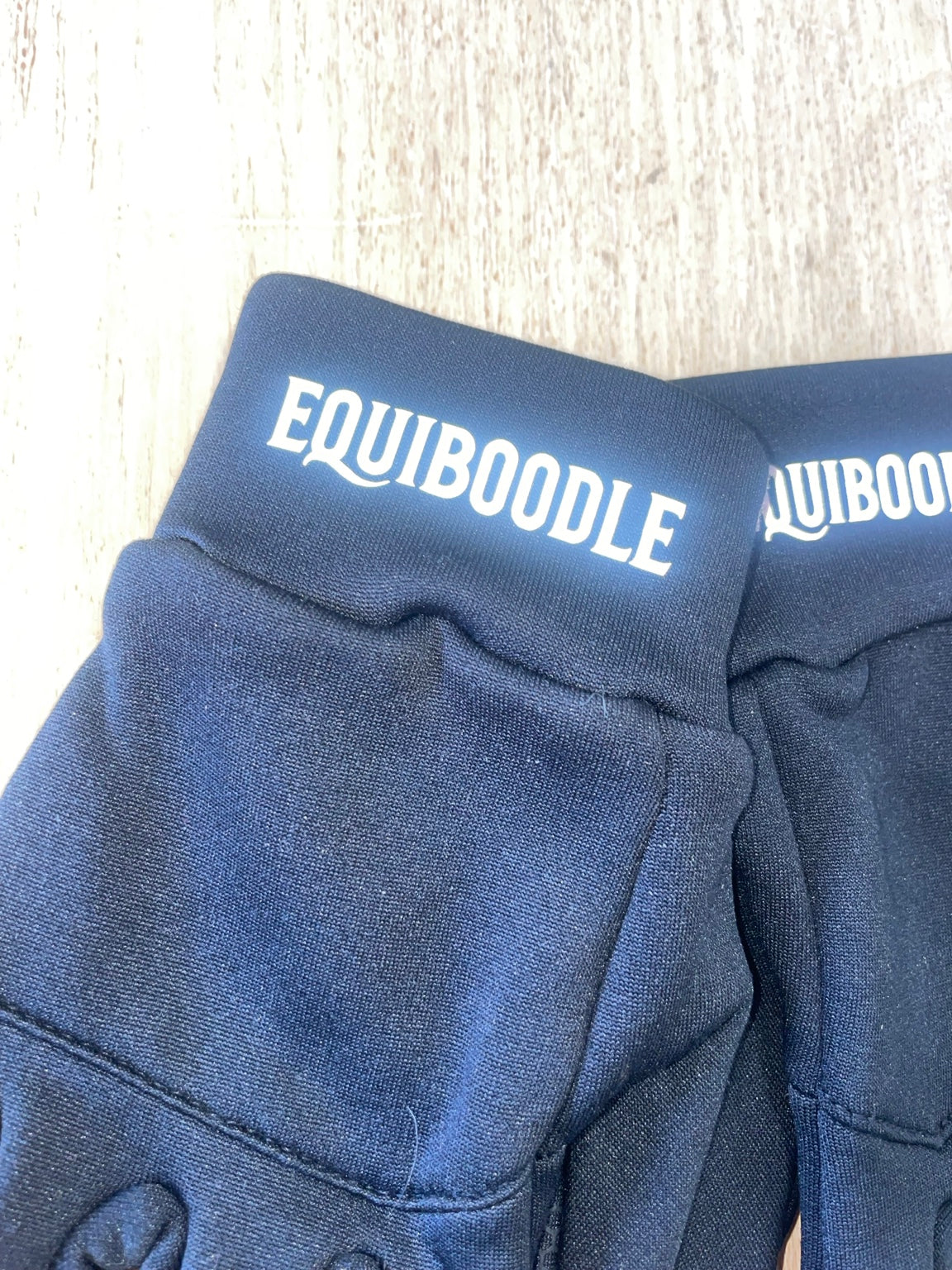 Equiboodle glove cuff logo reflecting light with flash