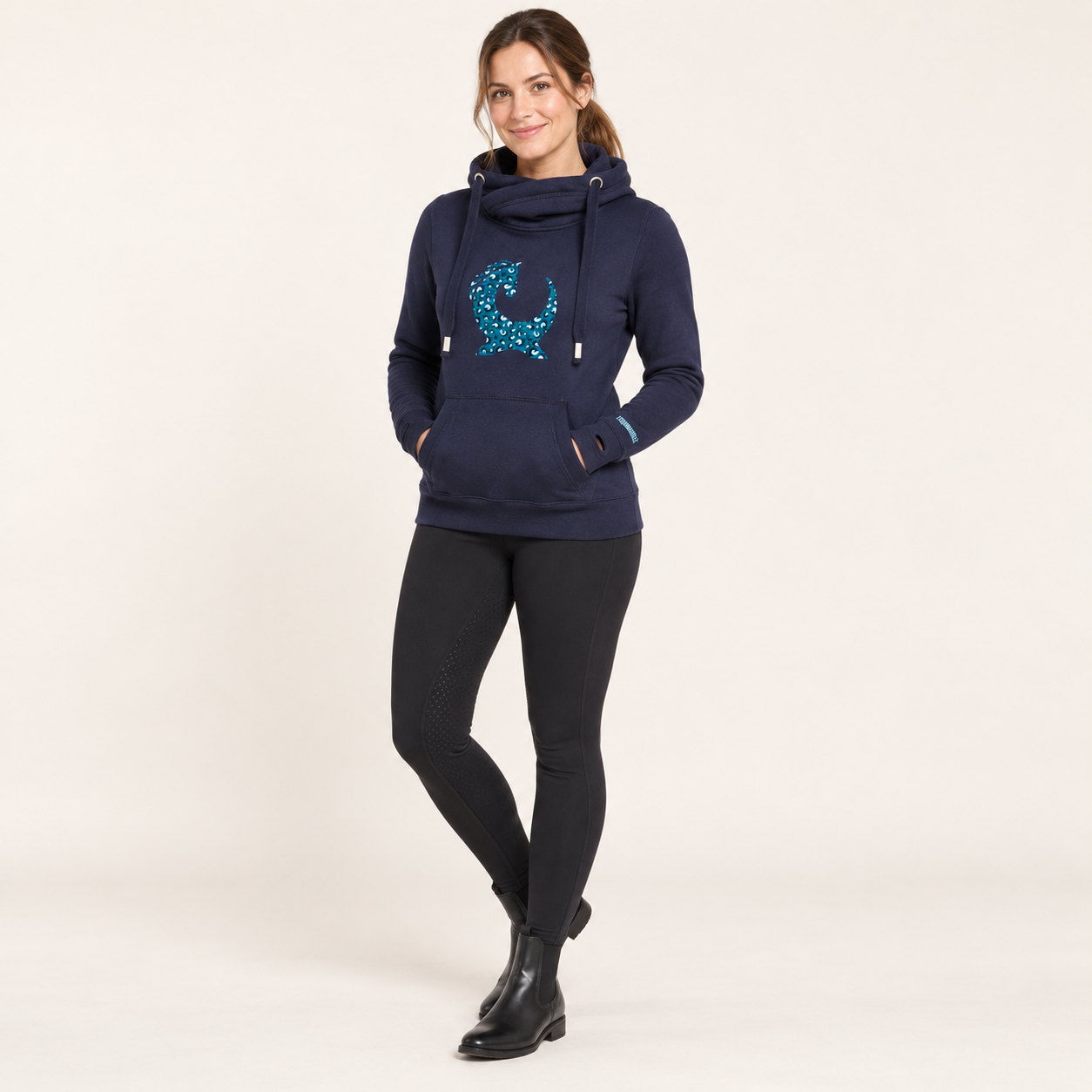 Model wearing the Equiboodle Teal Leopard Vixen cowl-neck hoodie in the studio
